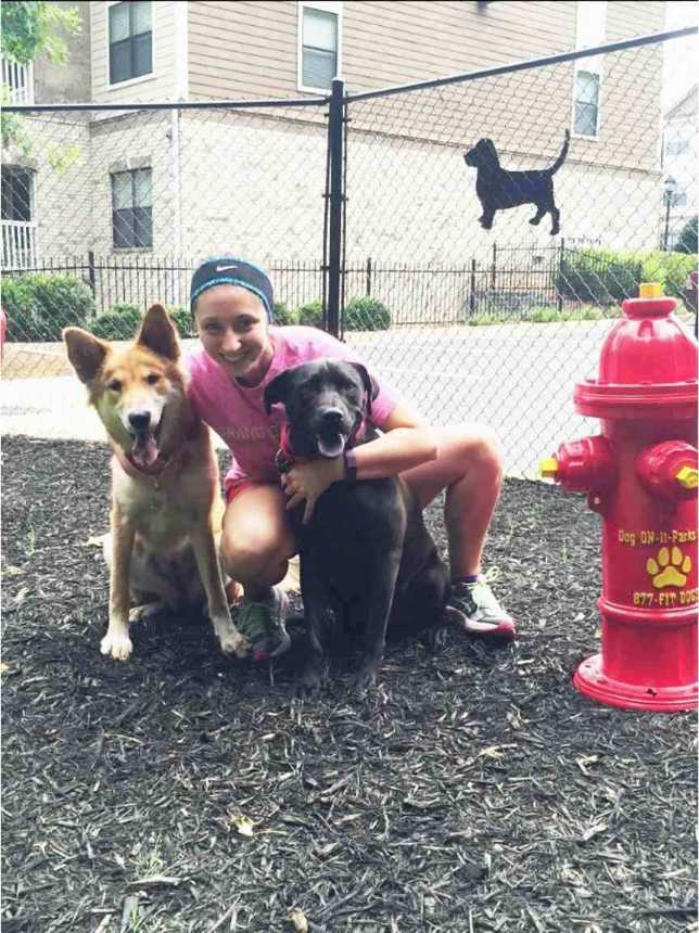 A dog owner with her two dogs